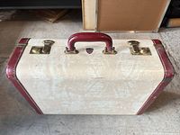Top view showing handle, latches, shield badge, cream body and red trim