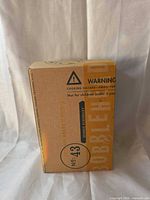 Closed box showing warning and item number 43