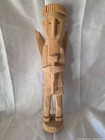 full frontal view of wooden angel statue showing entire form
