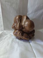 front view of polished wooden Weeping Buddha figurine