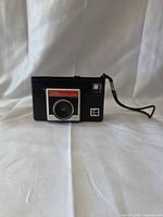 Front view showing model label, lens, viewfinder