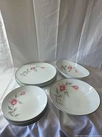 Stack of dinner plates, two oval serving bowls, two soup/salad bowls showing pattern