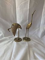 Front view of both brass bird figurines