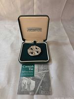 Brooch in open South Crofty Collection box with certificate visible