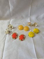 All five earring pairs arranged on cloth