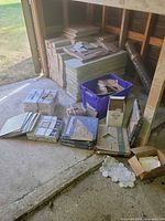 Overall view of stacked tile boxes, loose panels, hexagon mosaics