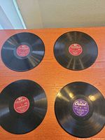 Four 10" 78 RPM records displayed label-side up