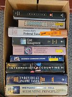 Boxed stack showing textbook spines for title identification