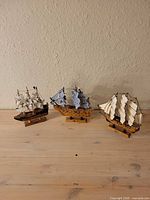 Three model ships front view on table