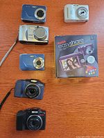 Five Kodak cameras displayed with Kodak EasyShare retail box