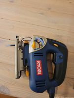 Left side view of Ryobi JS480L jigsaw showing body, handle and power cord