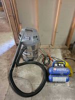 Shop-Vac vacuum with hose and Campbell Hausfeld compressor with hose