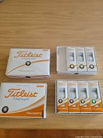 Front view of two retail boxes showing Titleist Velocity branding and windowed sleeves