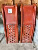 Front view of both red steel ramps standing upright