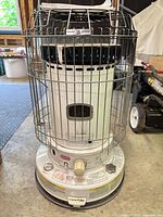 Front view of Dyna-Glo heater showing controls, cage and overall condition