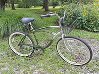 Full side profile of green and silver Fuji cruiser bike with front basket