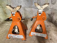 Front view of both orange Indy 5 jack stands showing labels, ratchet posts, release handles