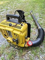 Side view of yellow John Deere backpack leaf blower with hose attached