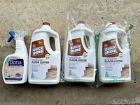 Group of all four bottles: one Bona spray, three Quick Shine jugs