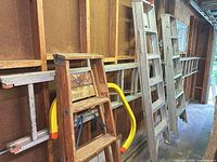 Overall view of four ladders and accessories in garage