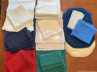All linen sets grouped by colour showing napkins, placemats, tablecloth and runner
