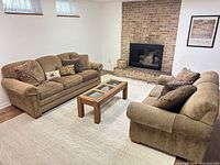 Sofa and loveseat in living room setting with coffee table (table not included)