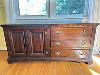 Front view showing overall design with drawers and cabinet doors