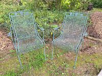 Both metal patio chairs side by side outdoors