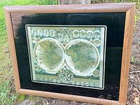 Front view of framed world map print showing artwork, mat and frame