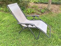 Front view showing full chair, beige sling, black frame