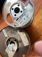 Top view of white wire spool showing label Nexans CanaDEX 2C14 NM90 CU, metal flange
