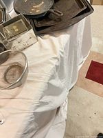 Overview showing cast iron skillet, baking sheets, mesh strainer, and loaf pans