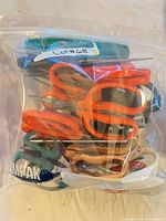Bag containing multiple scissors of various colors and sizes