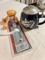 All four items grouped: stein, massager, packaged foot bolt, partial view