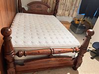 Full bed view showing headboard, footboard, mattress, box spring