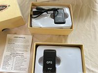 Two boxed GF-07 GPS trackers with cable and manual