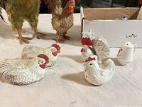 Five ceramic shakers and figures on table