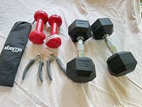 All items laid out: pair 17.5 lb hex dumbbells, pair 3 lb vinyl dumbbells, pair hand grippers, Xtreme Bands pouch with bands