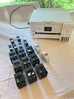 Lot overview with Epson ET-2760 printer and array of circuit breakers