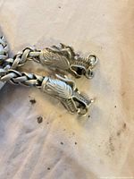 Close-up of dragon head terminals and hook clasp