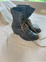 Side view of both boots showing uppers, laces and eyelets