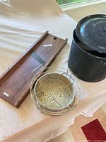 wooden mandoline, enamel stockpot with lid, metal steamer insert displayed overall