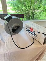 Vortex VTX600 fan beside boxed ThermoFlo 2000SR duct