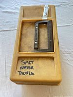 Closed yellow tackle box showing lid text and handle