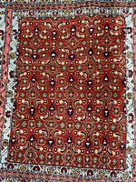 Close view highlighting red field with geometric motifs