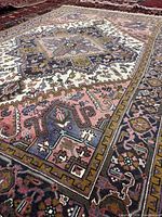 Angled view showing texture and colors of Heriz rug