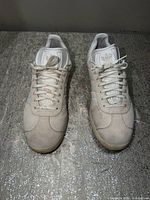 Top view of both sneakers showing uppers, laces, tongue logo