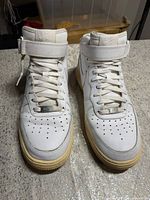 Frontal view of both shoes showing uppers, laces, straps, and general condition.