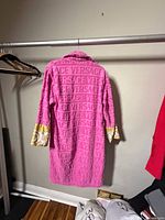 Front view of the pink Versace bathrobe on hanging rail