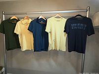 front view of five shirts hanging